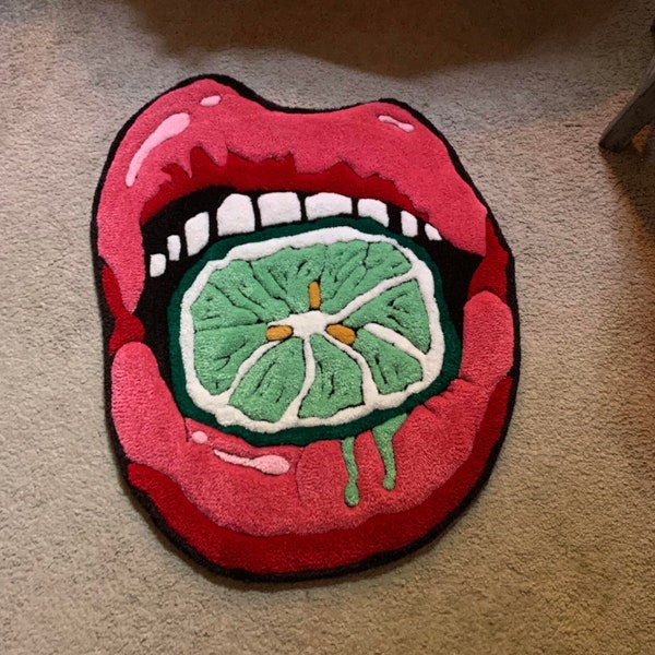 Decorative tufted rug in shape of lips with lime