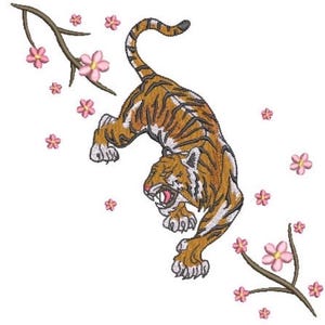 May include: An embroidery design featuring a prowling tiger with orange and black stripes, white accents, and an open mouth. The tiger is surrounded by two brown branches with small pink cherry blossom flowers scattered around the central figure.