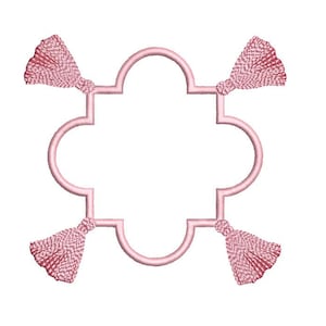 May include: A pink quatrefoil frame with four pink tassels attached to each corner.