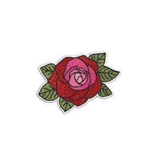 May include: An embroidered patch featuring a central rose with deep red outer petals and a bright pink center, surrounded by several green leaves with visible stitching details, all outlined with a white border against a plain background.