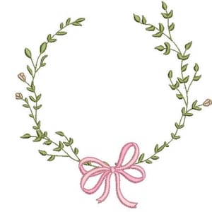 May include: An embroidery design featuring a circular wreath of thin green stems with small leaves and tiny pink flower buds. At the bottom center, a pink ribbon is tied into a bow with two trailing ends, completing the circular floral frame.