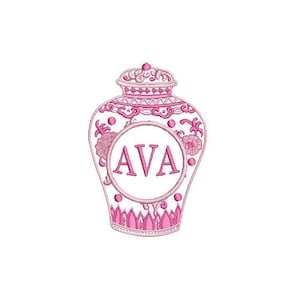 May include: Pink and white porcelain jar with a floral design and the name "AVA" in a circle in the center.