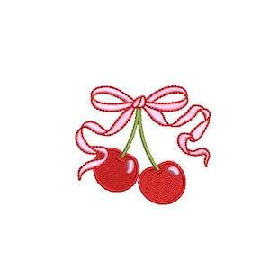 May include: Two red cherries with green stems and a pink ribbon tied around the stems.