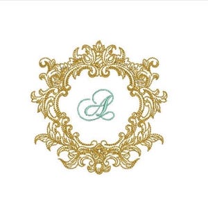 May include: An embroidery design featuring a gold-colored, ornate, scrollwork frame in a circular shape. Centered within the frame is the letter A, stitched in a light blue, cursive script font. The entire design is set against a plain white background.