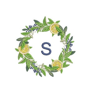 May include: A wreath made of green leaves and yellow lemons with a blue letter "S" in the center.