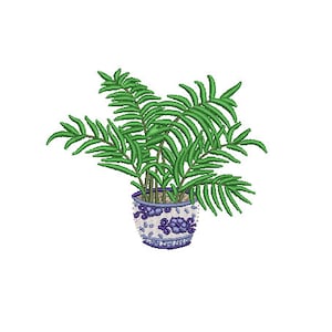 May include: An embroidered image of a potted plant. The plant has green fronds and is in a blue and white decorative pot. The image is set against a white background, highlighting the detailed stitching of the leaves and pot design.