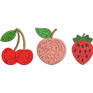 May include: Three embroidered fruit patches: a pair of red cherries with green stems and leaves, a peach with a pink and white colour scheme, and a red strawberry with green leaves and black seeds.