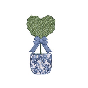 May include: A heart-shaped topiary plant with a blue ribbon tied around the trunk, potted in a blue and white patterned ceramic pot.