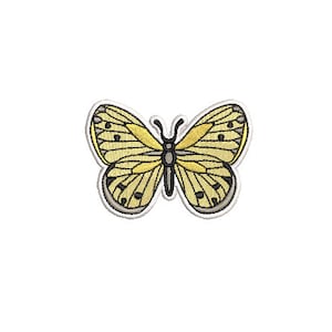 May include: A yellow butterfly with black markings on its wings. The butterfly is embroidered on a white background.