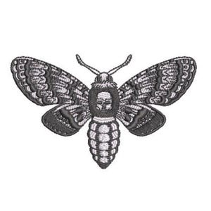 May include: An embroidered moth design featuring a detailed skull pattern on the thorax. The insect is rendered in shades of dark gray and white thread, showcasing intricate wing textures, symmetrical patterns, and two thin antennae extending upward.