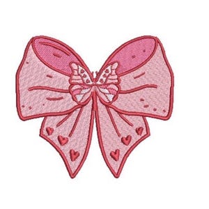 May include: An embroidered patch shaped like a bow with a butterfly at the center. The design features various shades of pink with dark pink outlines. The bow has small heart-shaped accents on the lower sections and a textured stitch pattern.
