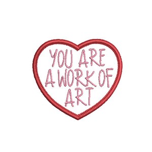 May include: A red heart-shaped outline with the text "YOU ARE A WORK OF ART" in pink lettering inside.