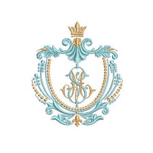 May include: An embroidery design featuring a central monogram with the letters M and S intertwined in gold thread. The monogram is surrounded by a light blue decorative shield frame with gold beaded accents and a gold crown at the top.