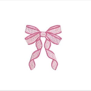 May include: A light pink embroidered bow design featuring a central knot and two long, flowing ribbon tails. The embroidery consists of a dense, textured stitch pattern with a darker pink outline defining the edges of the bow and the ribbon tails.