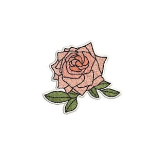 May include: An embroidered patch featuring a stylized rose in shades of soft peach and coral with dark outlines. The flower is accompanied by three green leaves with visible stitching details, all set against a clean white background.