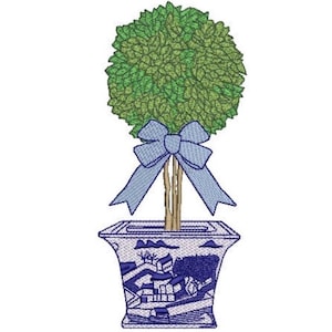 May include: An embroidered design of a topiary tree with a round green canopy and a light blue bow tied around its brown trunk. The tree is planted in a square, flared planter featuring a blue and white landscape pattern with buildings.