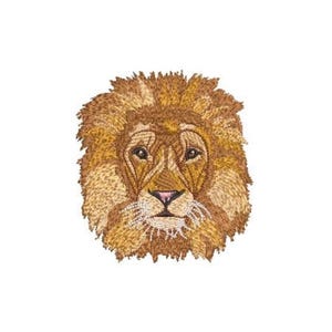 May include: An embroidered patch featuring the head of a lion. The design uses various shades of golden, brown, and tan thread to create the mane and facial features. The lion has a pink nose, dark eyes, and white whiskers against a white background.