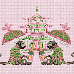 May include: An embroidery design on a light pink background featuring two brown monkeys wearing green and pink patterned jackets. Each monkey holds a champagne bottle, and above them is a pink and green pagoda structure with two green umbrellas.
