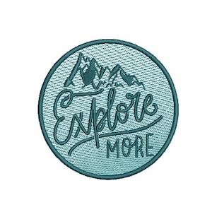 May include: A blue and white embroidered patch with a mountain range and the text "Explore More".