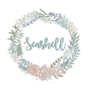 May include: An embroidery design featuring a circular wreath of light blue and soft pink seaweed, coral, and starfish elements. The word Seashell is stitched in the center in a light blue cursive script font against a plain white background.