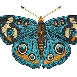 May include: An embroidered butterfly patch featuring vibrant shades of turquoise, deep brown, and gold. The wings display intricate circular eye-spot patterns in black, white, and blue, with two thin, light-colored antennae extending from the top.