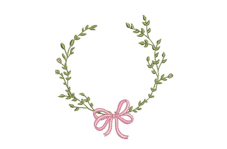 May include: An embroidery design featuring a circular wreath of green leafy branches and small buds. At the bottom center, a pink ribbon is tied into a bow with a white stitched outline, creating a decorative element for textile projects.