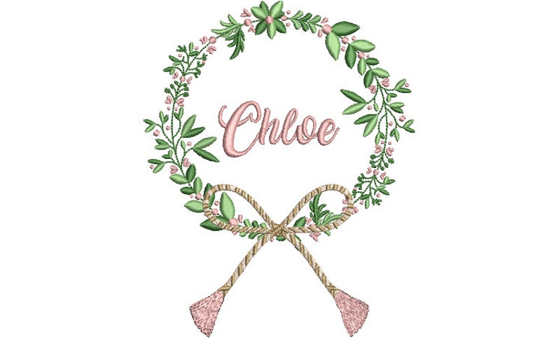 May include: An embroidery design featuring a circular wreath of green leaves and small pink flowers. The name Chloe is stitched in pink cursive script in the center. At the bottom, a tan rope-style bow with two dangling tassels completes the motif.