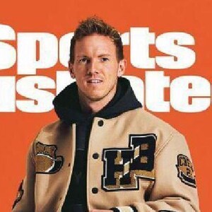 May include: Sports Illustrated Germany magazine cover featuring a man in a tan and black letterman jacket. The cover has the text "Sports Illustrated" and "DER NAGELSMANN FAKTOR" in large white letters. A soccer ball is at the man's feet.