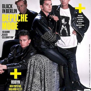 May include: Magazine cover with Depeche Mode, featuring text in yellow and white. The cover includes the text "BLACK IN BERLIN DEPECHE MODE 40 JAHRE BLACK CELEBRATION". The band members are wearing black leather jackets and trousers.