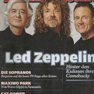 May include: A Rolling Stone magazine cover featuring three men in black shirts. The headline reads Led Zeppelin, with additional text including Die Sopranos, Maximo Park, and Cat Power. The top banner lists Magnetic Fields, Joe Jackson, and Nico.