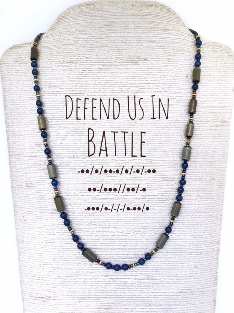 Handcrafted beaded necklace featuring Morse code pattern spelling out 'defend us in battle'. Muted colors of green and and blue spell out the St Michael prayer quote.