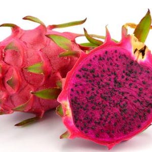 May include: Two dragon fruits, one whole and one cut in half, revealing the bright pink flesh with black seeds. The fruit has a vibrant red skin with green scales.