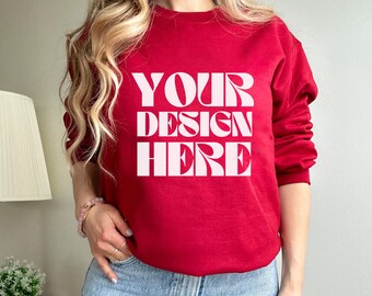 May include: A red sweatshirt with the text "YOUR DESIGN HERE" in white.