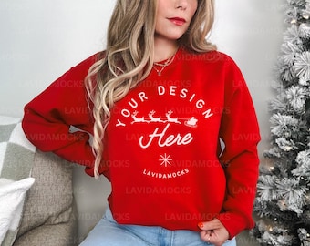 May include: Red sweatshirt with a white design that says "Your Design Here" with a snowflake and reindeer graphic.