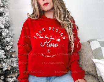 May include: Red sweatshirt with a white design that says "Your Design Here" with a snowflake and a reindeer pulling a sleigh.