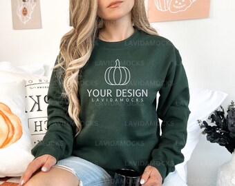 May include: A dark green sweatshirt with a white pumpkin graphic and the text "YOUR DESIGN" on the front.