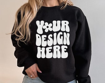 May include: A black sweatshirt with a white graphic that says "YOUR DESIGN HERE" in a retro, psychedelic font.