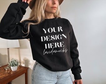 May include: A black sweatshirt with the text "YOUR DESIGN HERE lavidamocks" printed on the front.