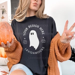 May include: A black t-shirt with a white ghost graphic and the text "Your Design Here" in a circle with the text "Estd 2024".