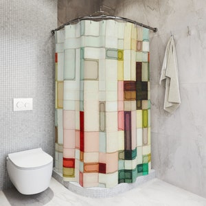 The shower curtain shown has a geometric pattern made up of squares and rectangles in varying sizes. These shapes are filled in with watercolor and are arranged in a random pattern. Colors include shades of pink, peach, yellow, red, green, and brown.