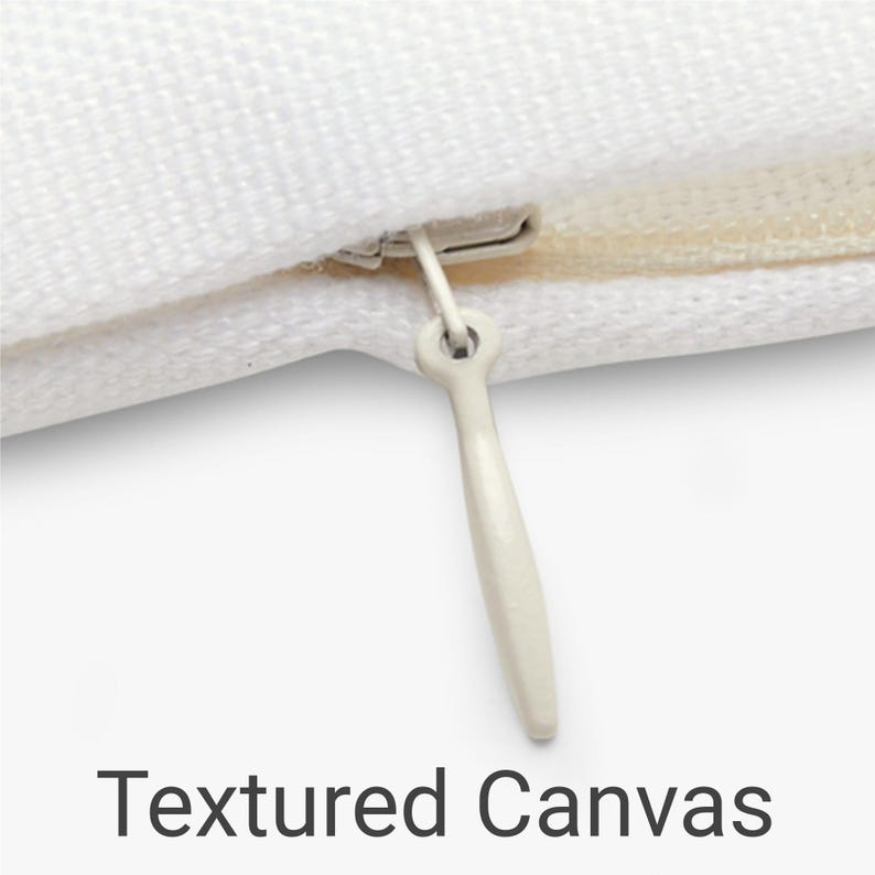 Close-up of a blank, white, textured canvas pillow cover with a hidden zipper, highlighting durable weave & neat stitching.