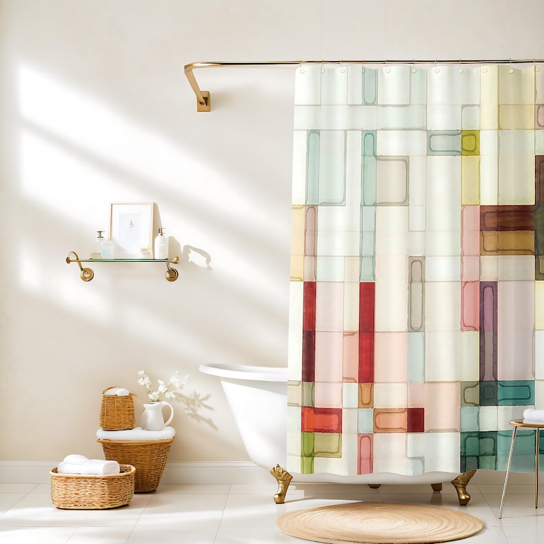 The shower curtain shown has a geometric pattern made up of squares and rectangles in varying sizes. These shapes are filled in with watercolor and are arranged in a random pattern. Colors include shades of pink, peach, yellow, red, green, and brown.