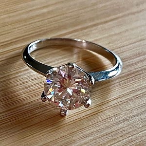 Moissanite ring. A gorgeous 3ct certified round brilliant Moissanite in a lovely crown setting, with 6 prongs and a sleek plain band!