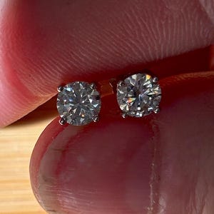 1cttw certified Moissanite studs, D-color and VVS1 clarity! Small in size, substantial in sparkles! Perfect for second piercings or youths!