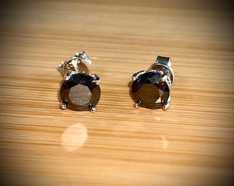 Moissanite studs. A 2cttw certified pair of black Moissanite studs in a sterling silver basket setting with 18k white gold plating!
