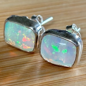 Ethiopian opal earrings, pair B. A beautiful pair of Ethiopian opal earrings, approximately 4cttw and hand-set in sterling silver bezels!