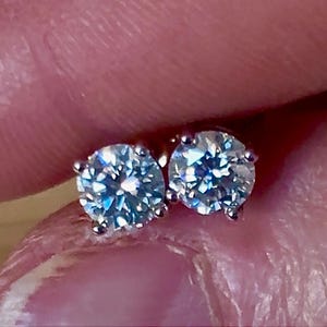 1cttw DOUBLE certified Moissanite studs with D-color and VVS1 clarity! Set in sterling silver bathed in 18k white gold, they’re a cut above!