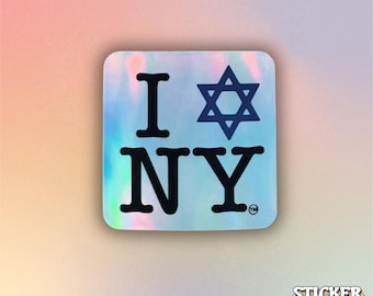 May include: A square holographic sticker featuring the black text I, a Star of David symbol, and the letters NY. The design includes a small trademark symbol next to the letter Y, all set against a reflective, iridescent background.