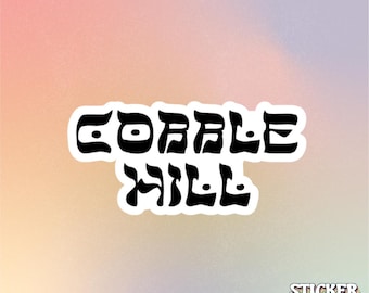 May include: A die-cut sticker featuring the black text COBBLE HILL in a wavy, stylized font with a white border. In the bottom right corner, the text STICKER KWEEN appears in a smaller, multi-colored, layered font design.
