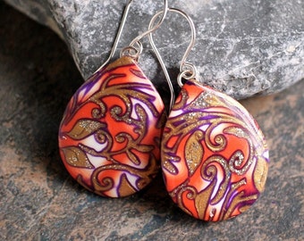 One of a kind dangle earrings. Botanical design earrings. Polymer clay drop shaped earrings. Orange purple petals. Sterling silver ear wires